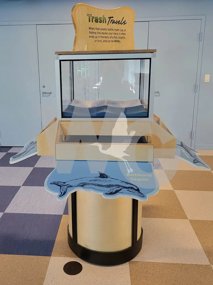 A 3D Plinko game exhibit with custom graphics on the ball catch trays and a wooden structure, placed on a checkered floor.